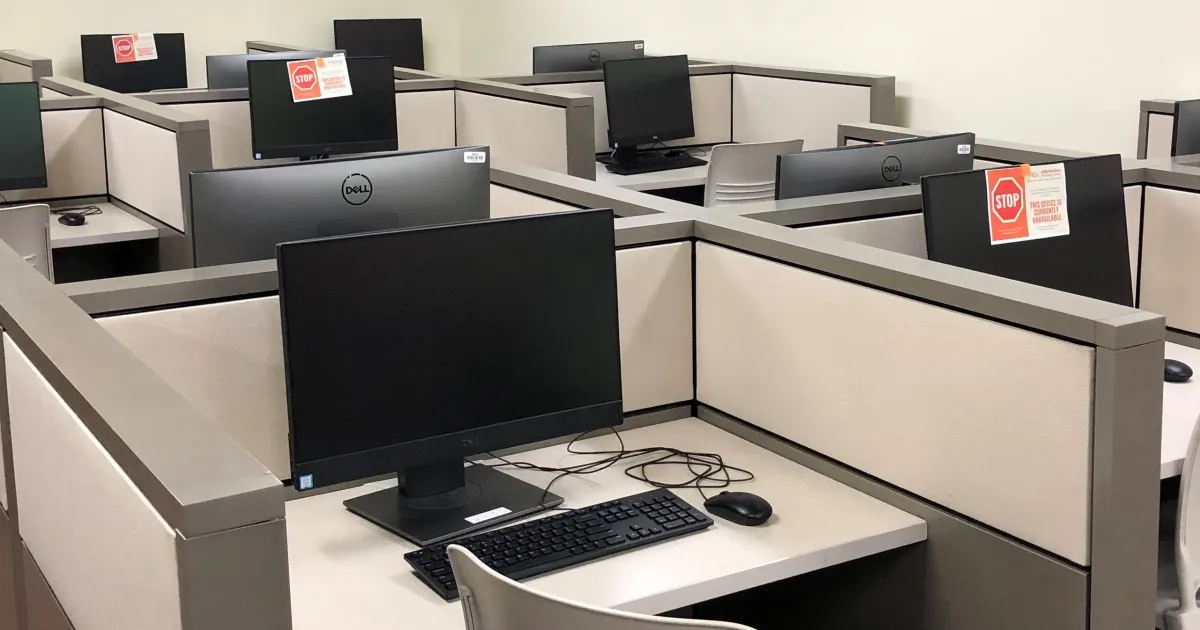 Rows of computer desks in an online exam centre